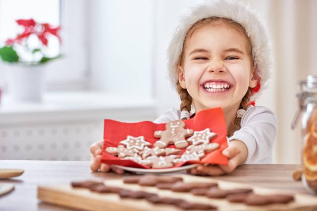 little girl cooking Christmas biscuits